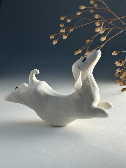 Small jumping dog in porcelain