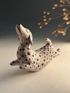 Small spotted jumping dog in mixed clay