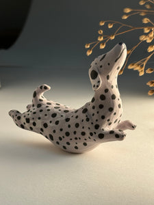 Small spotted jumping dog in mixed clay